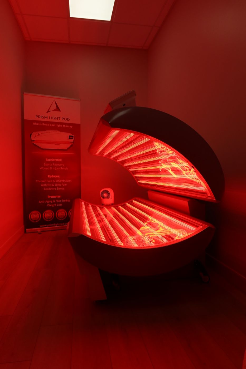 The Prism Light Pod open in the treatment room at Balanced Aesthetics + Wellness, Brookhaven